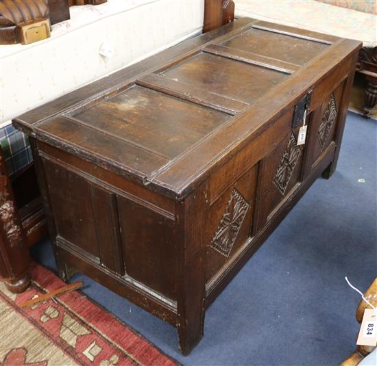 An 18th century carved oak coffer W.130cm